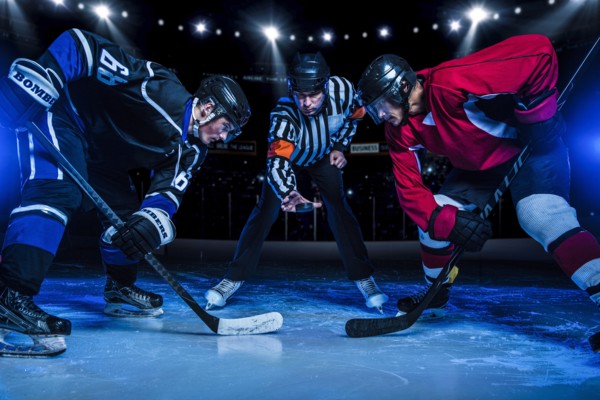 Hockey players and referee starting match