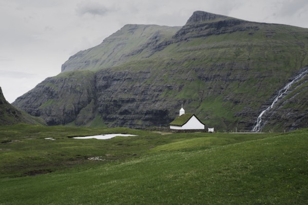 Denmark, Small church in green landscape with mountains,