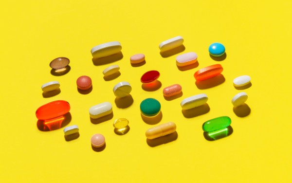 Pills and capsules on yellow