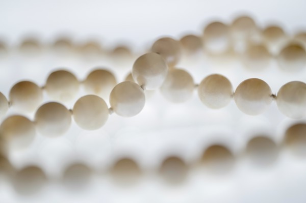 Close up of pearl necklace on white