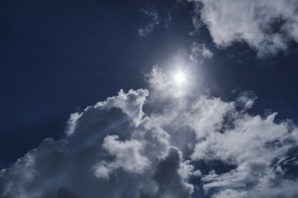 White clouds and sun on blue sky