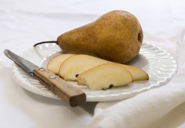 Sliced pear and knife on plate