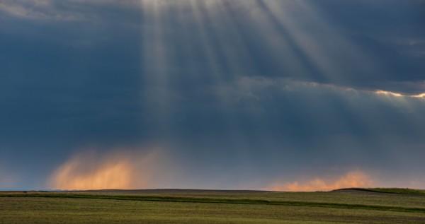 USA, South Dakota, Storm clouds at sunset over prairie