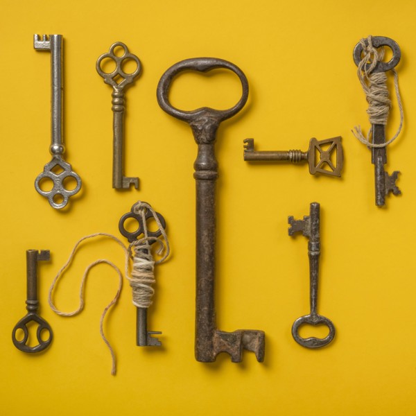 Antique keys on yellow background