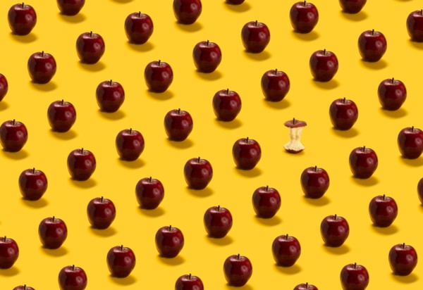 Large group of red apples on yellow background