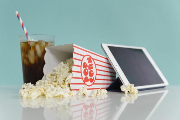Studio shot of popcorn with digital tablet and soda