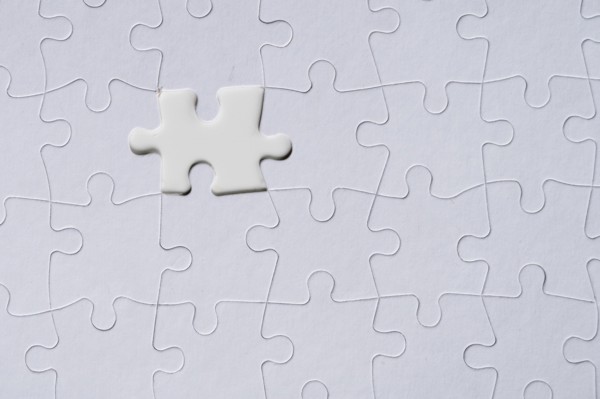 White jigsaw piece on jigsaw pattern