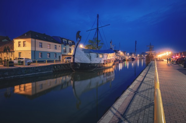 Poland, Pomerania, Leba, Historic ship moored in harbour at night