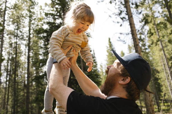 Father holding smiling daughter