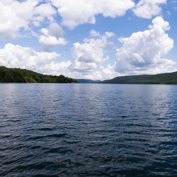 USA, New York, Cooperstown, Otsego Lake, Clouds over lake surrounded by hills