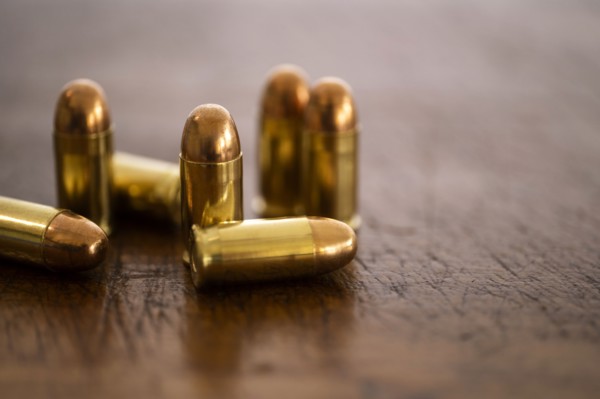 Gold bullets on wooden surface