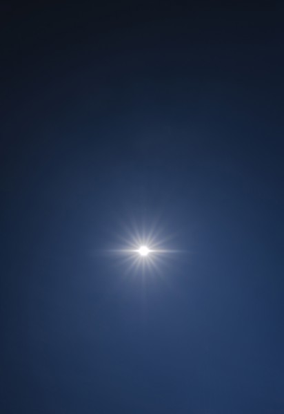 Sun shining on clear blue sky