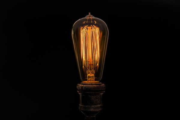 Edison light bulb on black background