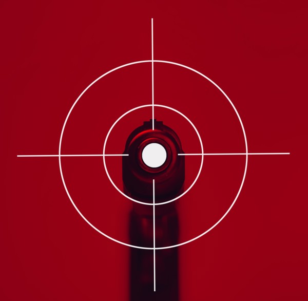 Shooting target on red background with gun