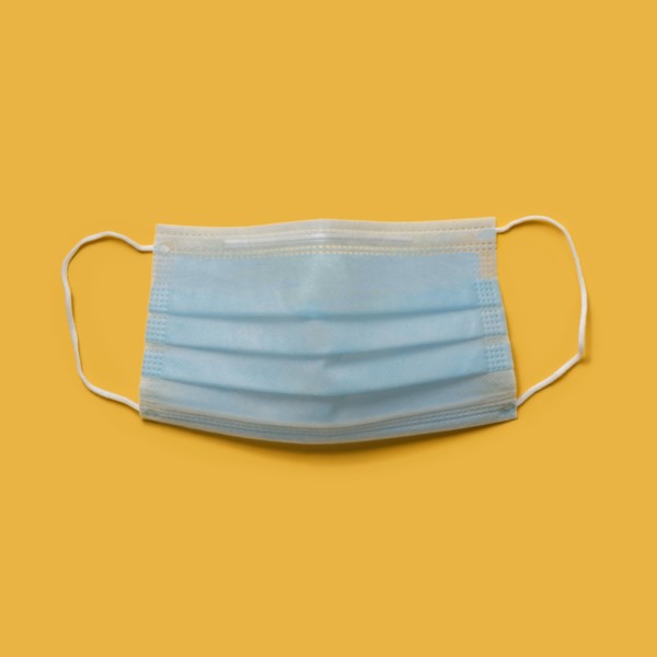 Flu mask on orange background