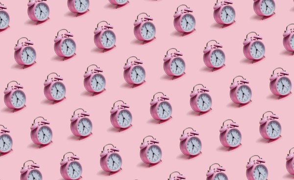 Alarm clocks on pink background
