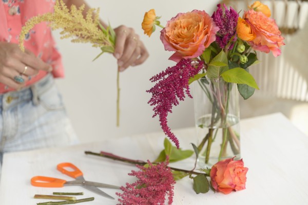 Woman making floral arrangement
