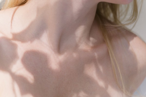 Shadow of leaves on woman's body