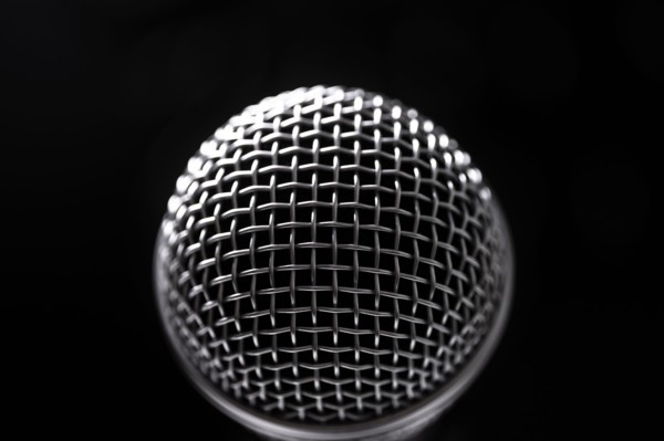 Close-up of microphone and stage lights