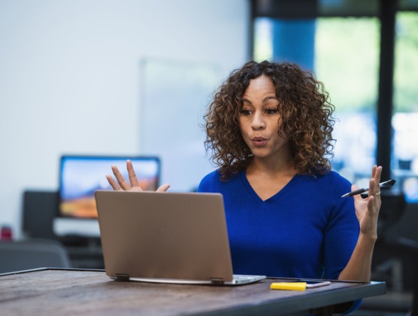 Woman looking at laptop at desk in office