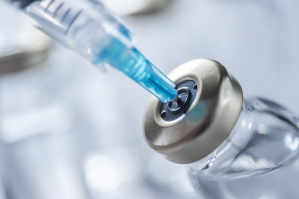 Close-up of Covid-19 vaccine and syringe