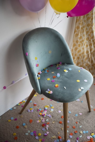 Confetti and balloons in room