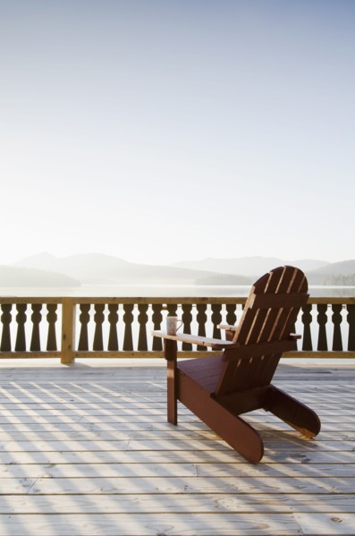 Adirondack chair on deck by lake
