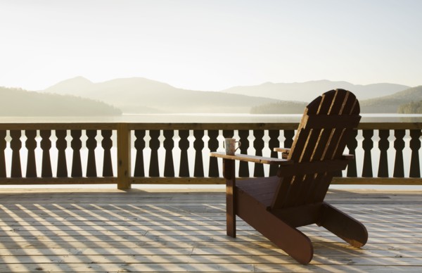 Adirondack chair on deck by lake