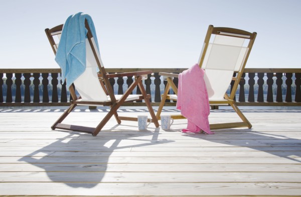 Canvas chairs on deck overlooking lake