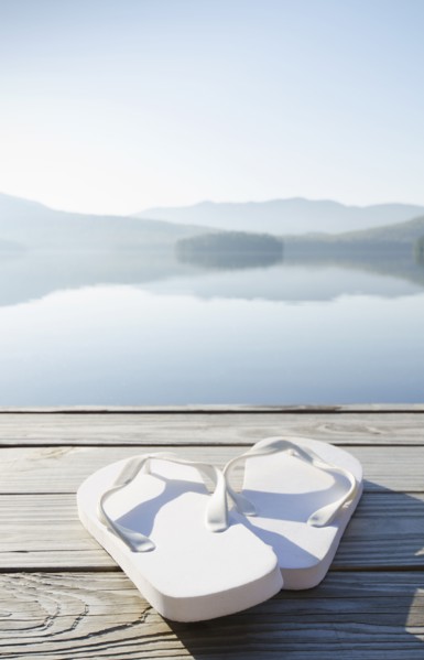 Pair of white sandals on dock