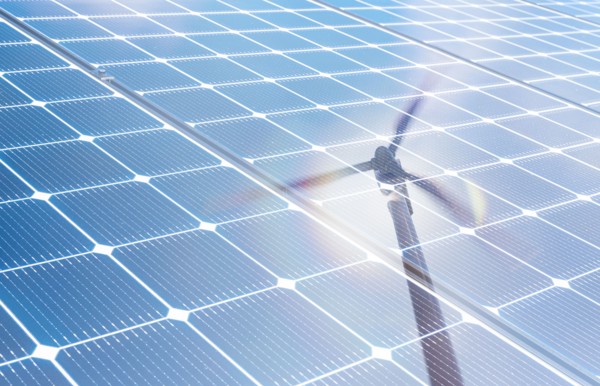 Wind turbine reflected in solar panels