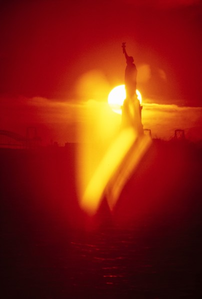Silhouette of Statue of Liberty at sunset