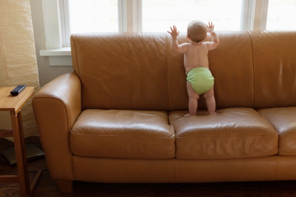 Baby boy playing on sofa