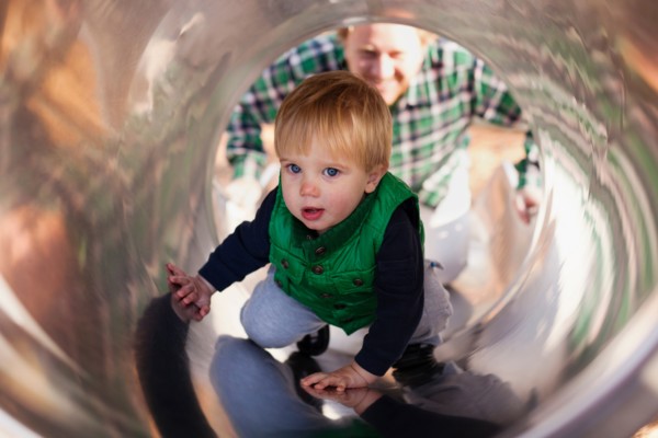 Boy climbing up slide in playground