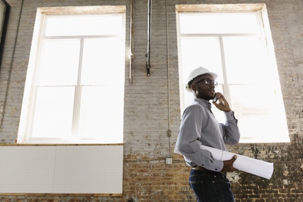 Young interior designer looking at new office space