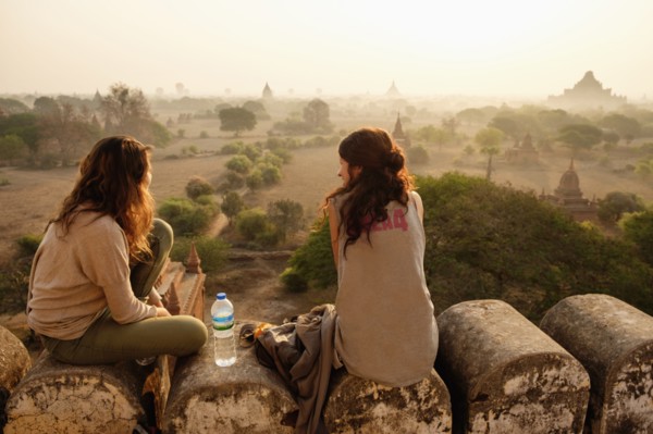 Women relaxing on stone wall