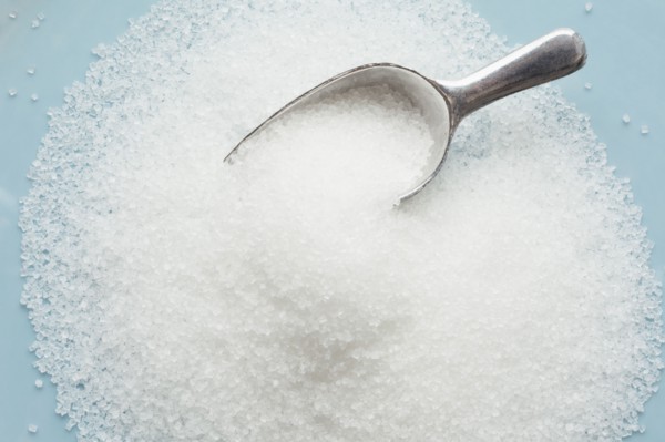 Studio shot of heap of sugar and scoop