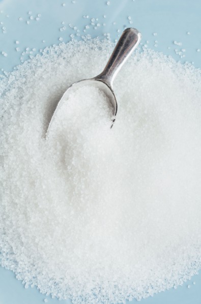 Studio shot of heap of sugar and scoop