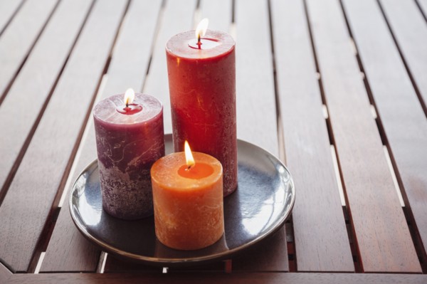 Candles and stones on wooden table