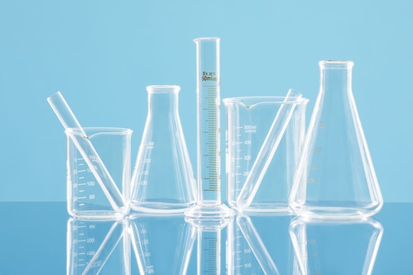 Laboratory glassware against blue background