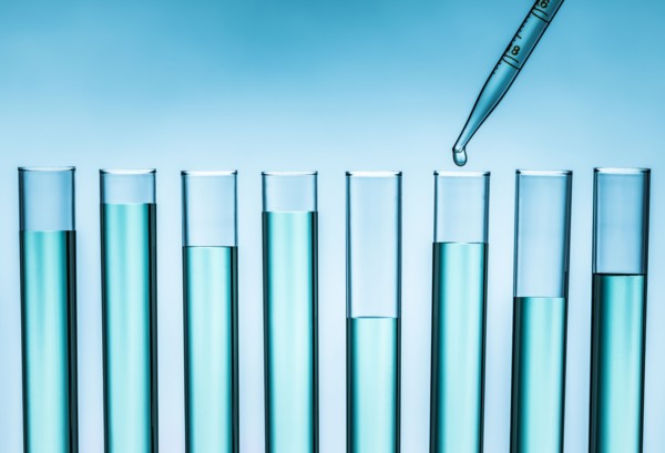 Pipette dropping liquid into test tube