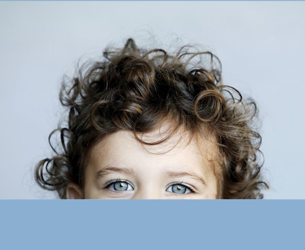 Portrait of little girl behind desk