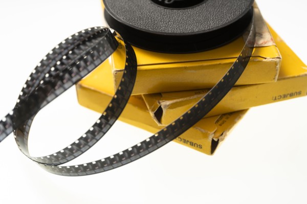 Studio shot of 8 mm film reel spool and boxes