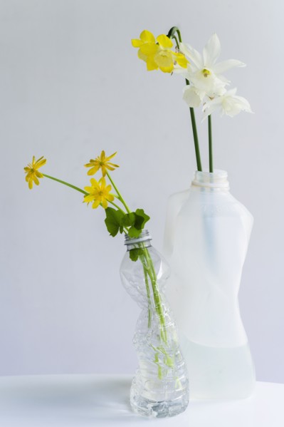 Spring flowers in crushed recycled plastic bottles