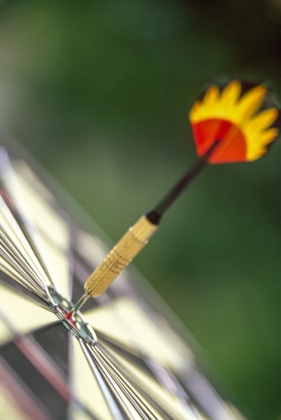Dart arrow in target center of dartboard