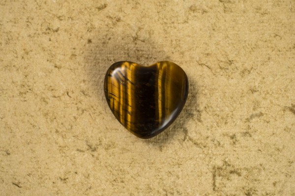 Wooden heart on beige background