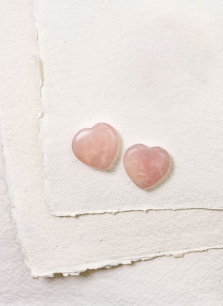 Glass hearts on white paper