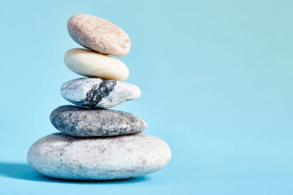 Stack of stones on blue background