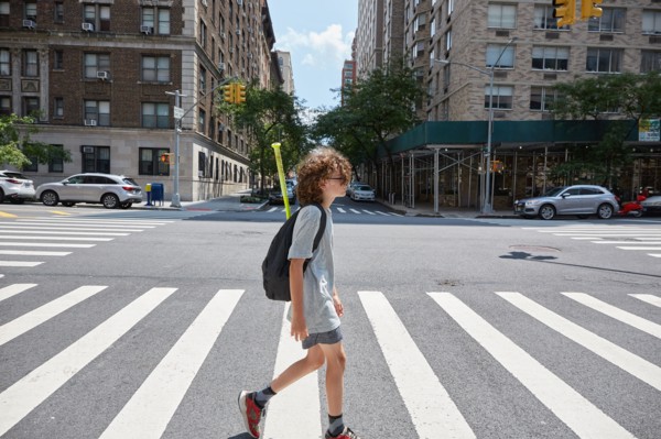 USA, New York, New York City, Boy crossing street