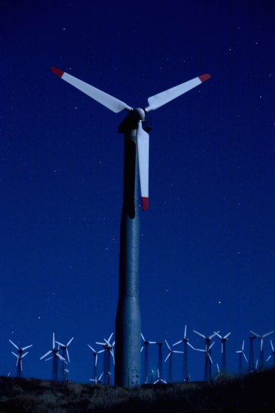 Wind turbines in landscape at night